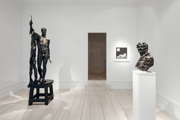 From Left: Damien Hirst, Saint Bartholomew, Exquisite Pain, 2006, bronze, 98.4 x 43.3 x 37.4 in (250 x 110 x 95 cm); Robert Mapplethorpe, Sleeping Cupid, 1989, Gelatin Silver Print, 24 x 20 in. (60.96 x 50.8 cm); Barry X Ball, Envy, 2008 – 2016, Italian Portoro Marble and stainless steel, 22 x 17 1/4 x 9 1/2 in. (55.9 x 43.8 x 24.1 cm), pedestal assembly: Macedonian Marble, stainless steel, wood, acrylic lacquer, steel, nylon, plastic, 46 x 14 x 12 in. (116.8 x 35.6 x 30.5 cm)